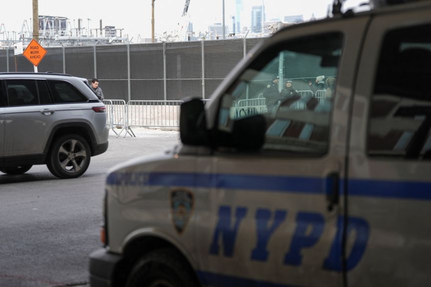 Police officers are pictured through a car window as they work outside the Metropolitan Detention Center in Brooklyn (MDC Brooklyn), where Captured Venezuelan President Nicolas Maduro is held after an initial court appearance to face U.S. federal charges including narco-terrorism, conspiracy, drug trafficking, money laundering and others in New York City, on January 5, 2026.