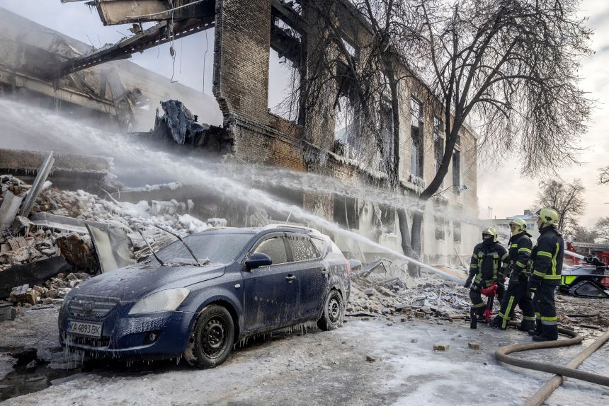 Firefighters work at the site of a building in Kyiv that was hit by a Russian drone on January 12, 2026.