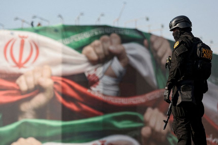 A member of the Iranian police observes a pro-government rally held in Tehran on January 12, as the country entered a third week of nationwide anti-regime protests.