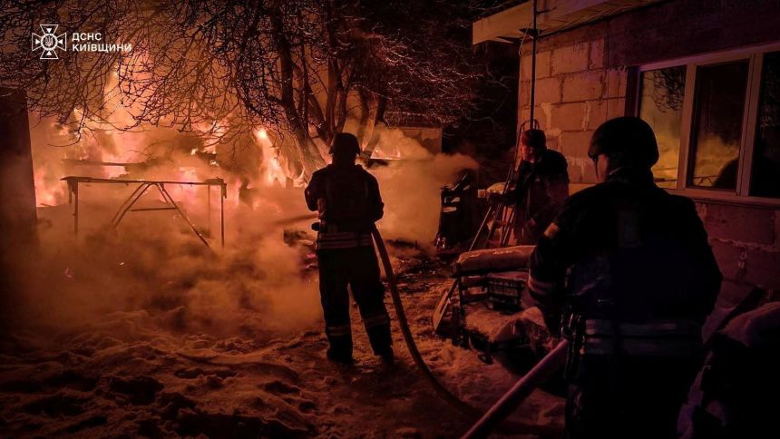Firefighters work at the site of a residential household damaged during Russian drone and missile strikes, on January 13, 2026.