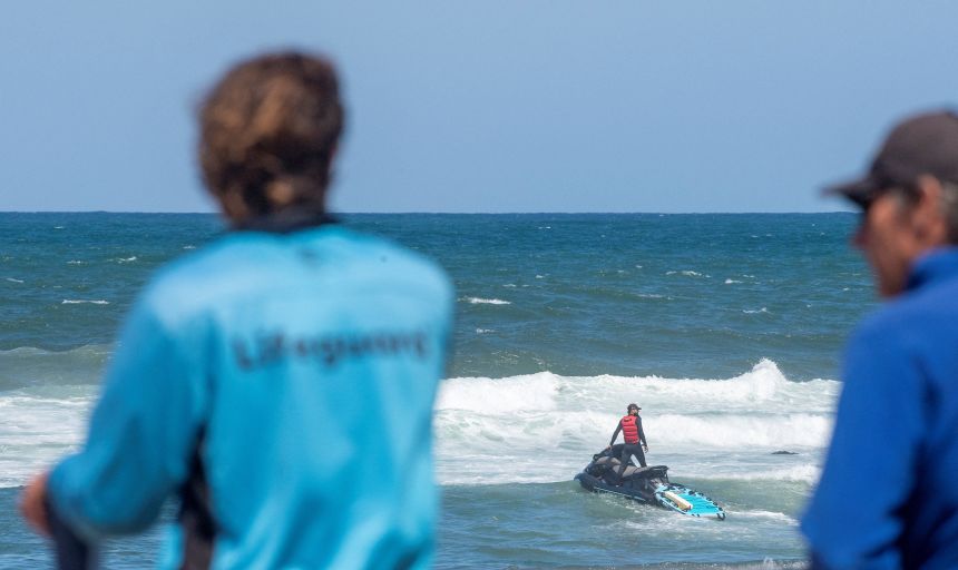 Lifeguards attempt to locate a shark that attacked a surfer today at Dee Why Beach in Sydney, Australia, on January 19, 2026.