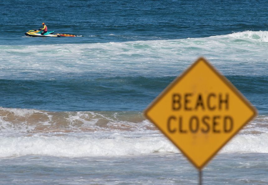 A lifeguard patrols North Steyne beach as beaches are closed after recent shark attacks, in Sydney, Australia, on January 20, 2026.