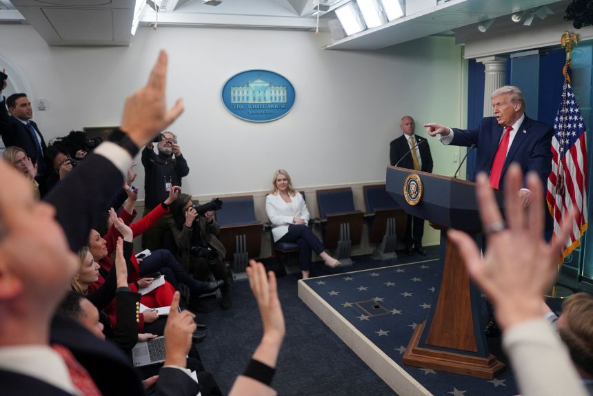 President Donald Trump points as reporters ask questions during a press briefing at the White House on January 20, 2026.