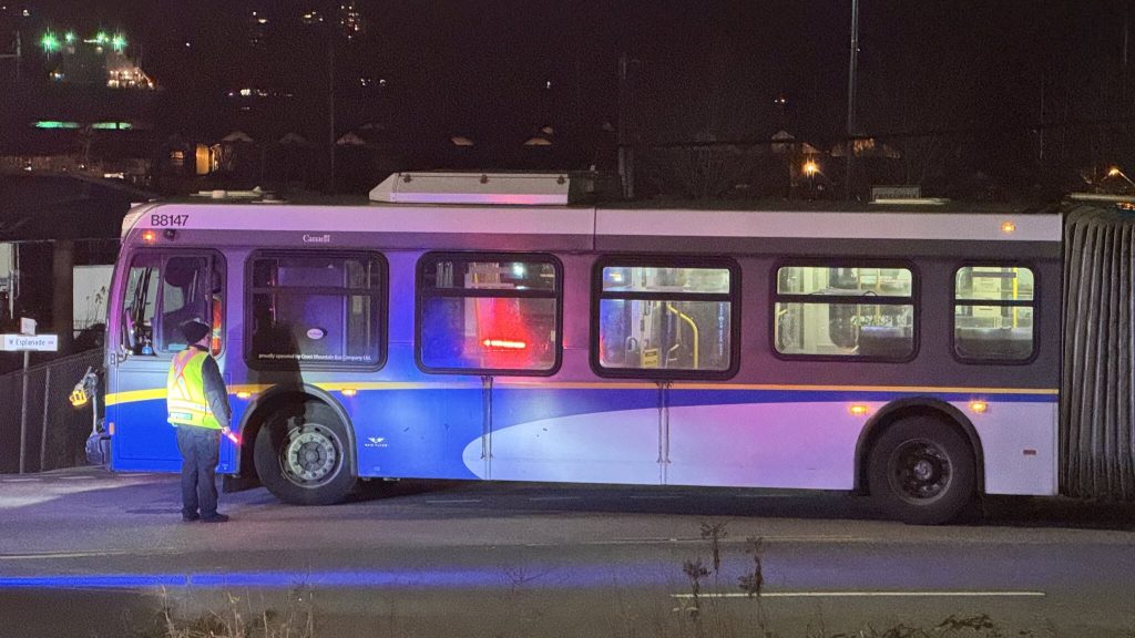 Police surround an articulated TransLink bus