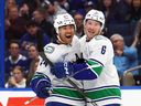 Vancouver Canucks winger Kiefer Sherwood celebrates his game-tying goal against the Tampa Bay Lightning with teammate Brock Boeser on Nov. 16 in Tampa, Fla.