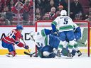 Goaltender Nikita Tolopilo  of the Vancouver Canucks stops Oliver Kapanen of the Montréal Canadiens during the game at the Bell Centre Jan. 12.