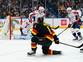 Brock Boeser scores a goal on Logan Thompson during the first period at Rogers Arena