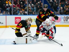 Martin Fehérváry of the Washington Capitals is dumped in front of Kevin Lankinen during the second period