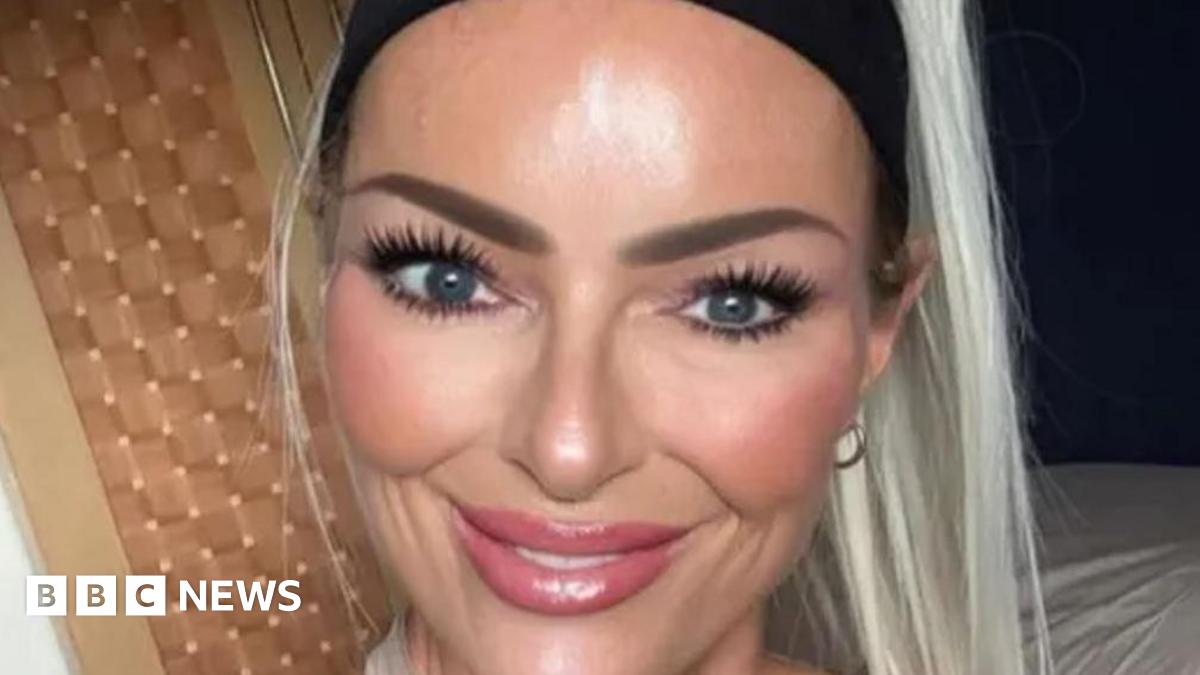 Jennifer Anne Brown has blonde hair and a black headband. She is smiling