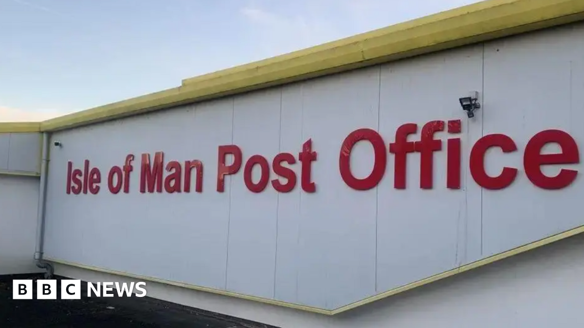 A wide shot of the Isle of Man Post Office sign. It is all written in red letters.