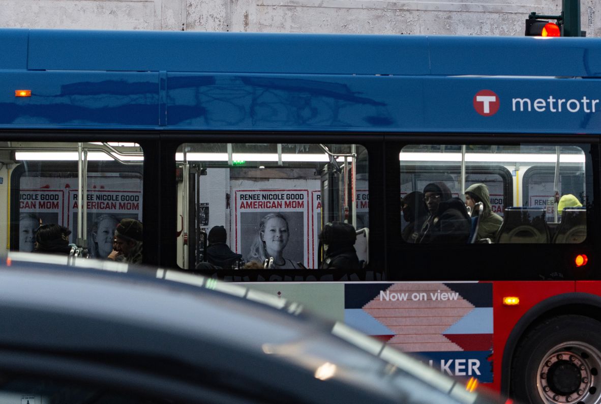 Posters honoring Renee Good are seen through the windows of a public bus in Minneapolis on January 15.