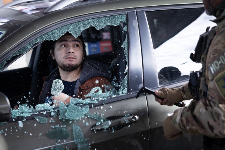 Federal agents smash a man's car window