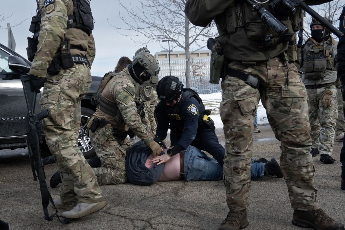 Federal agents take a demonstrator into custody outside the Whipple Federal Building on January 9.