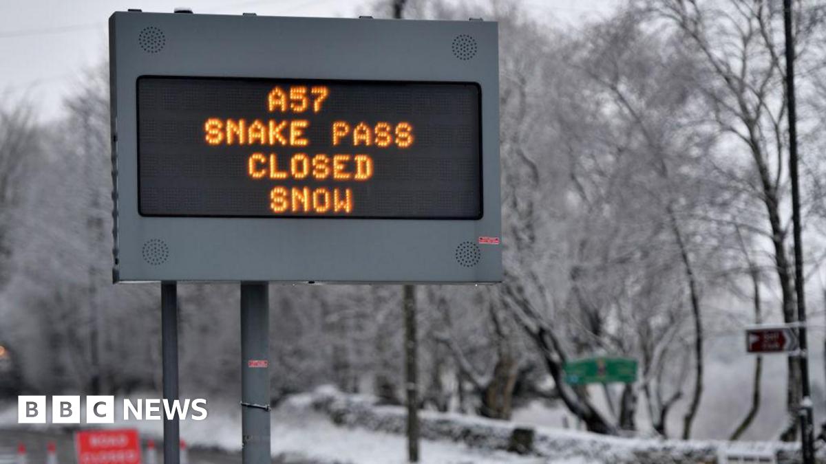 A sign saying the road is closed due to snow