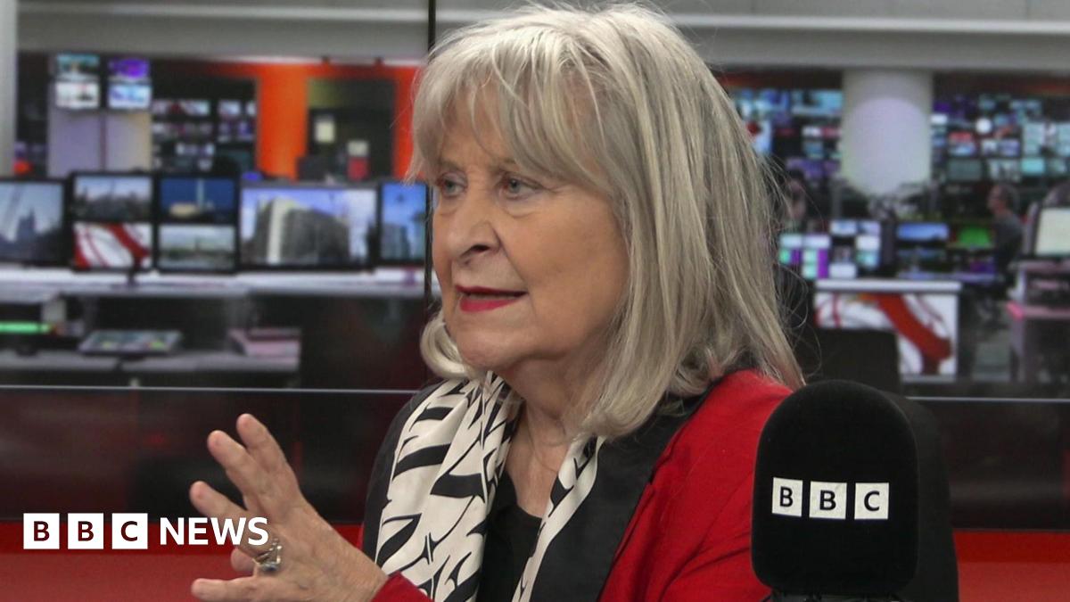 Headshot of Baroness Kennedy speaking in a BBC studio. She wears a red jacket with a black and white silk scarf.
