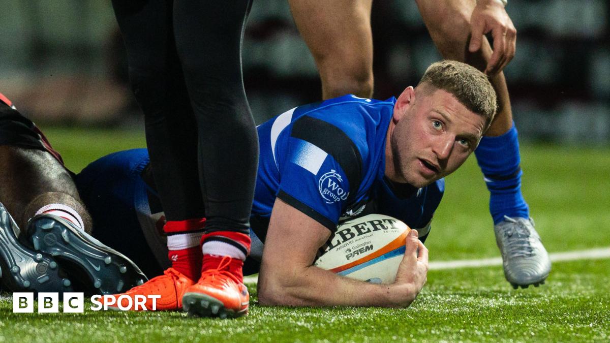 Finn Russell lies on the floor over the try line
