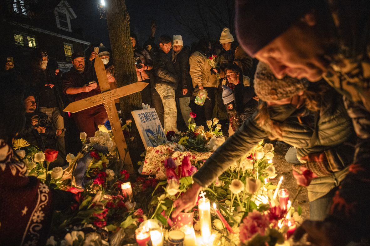 Mourners in Minneapolis light candles at a makeshift memorial for Renee Good on January 7.