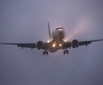 A Boeing 737 landing in foggy conditions.
