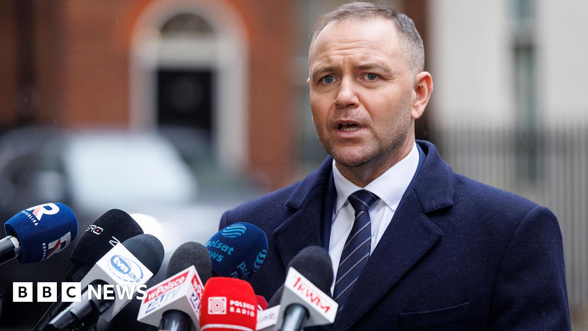 Prime Minister Mark Carney, wearing a black suit jacket, and a white button-up shirt leans his chin on his hands. He has short grey and black hair and is looking away from the camera.