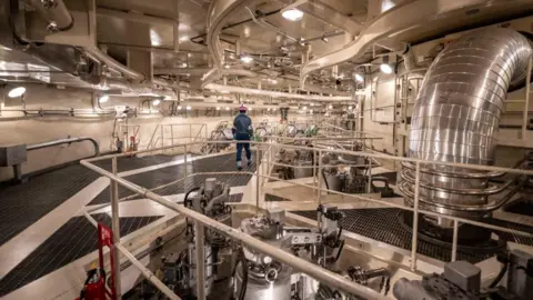 Getty Images Backview of a man walking through a nuclear power plant