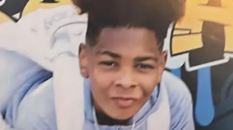 Family Handout/PA Images A photo of Kelyan, a boy of around 13, facing the camera. He has a high top haircut, and is wearing a light blue hoodie and white backpack. 