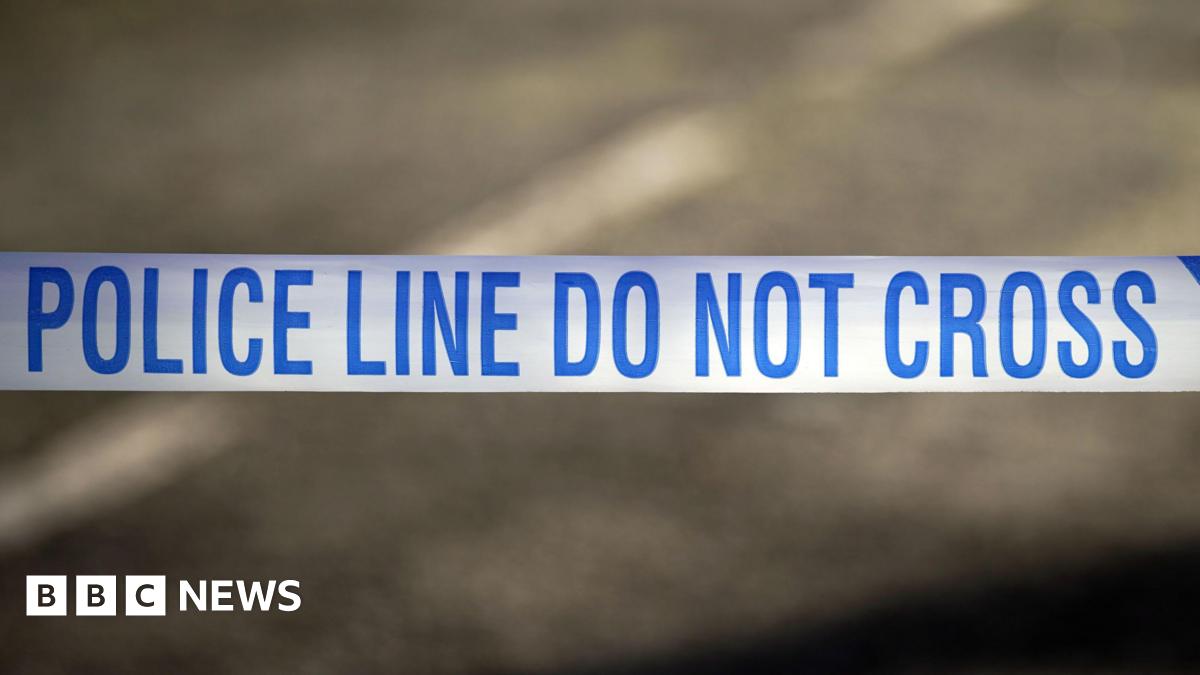 A white tape with the words police line do not cross written in blue.