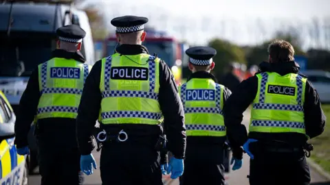 Getty Images Four police officers search for a missing person during an emergency services test response to chemical incident as part of training exercise
