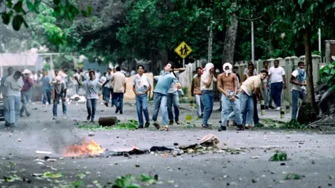 AFP via Getty Images Students from a western Caracas technical school confront police on June 10, 1992 during anti-government riots.