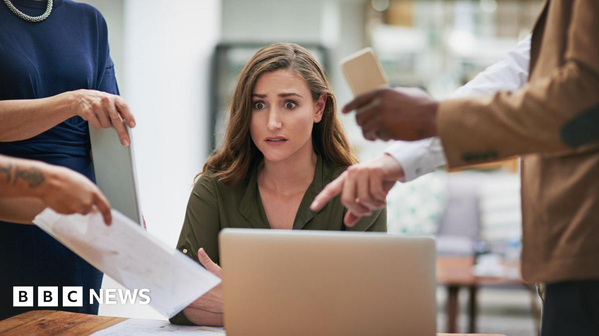Shot of a young businesswoman looking anxious in a demanding office environment
