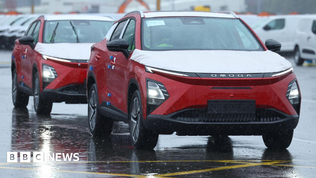 Two red Omoda E5 electric cars manufactured by Chinese automaker Chery are unloaded from a cargo ship at the Royal Portbury Dock, near Bristol.