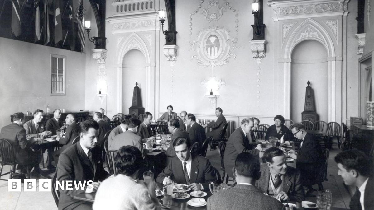 A black and white photo of a dinner banquet inside a 16th Century property.