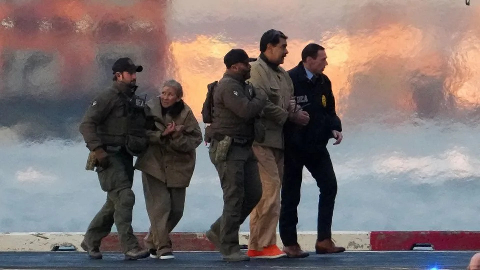 Law enforcement officials move captured Venezuelan President Nicolas Maduro and his wife Cilia Flores, second from left, out of the helicopter in New York on January 5. - Adam Gray/Reuters