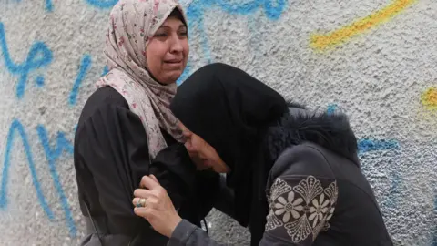 Reuters Palestinian women mourn during the funeral for people reportedly killed in Israeli strikes, at al-Shifa hospital, Gaza City, northern Gaza (22 January 2026)