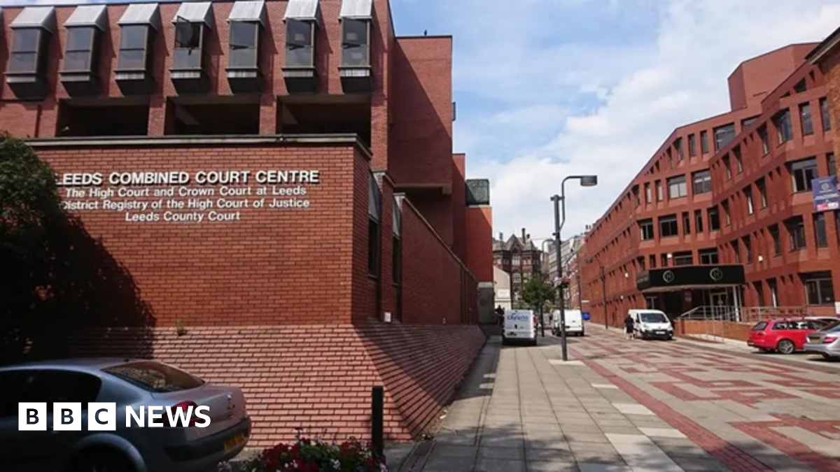 Exterior view of Leeds Combined Court Building, a red brick building with rectangular windows.