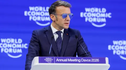 Reuters France's President Emmanuel Macron wears sunglasses as he attends the Davos economic forum