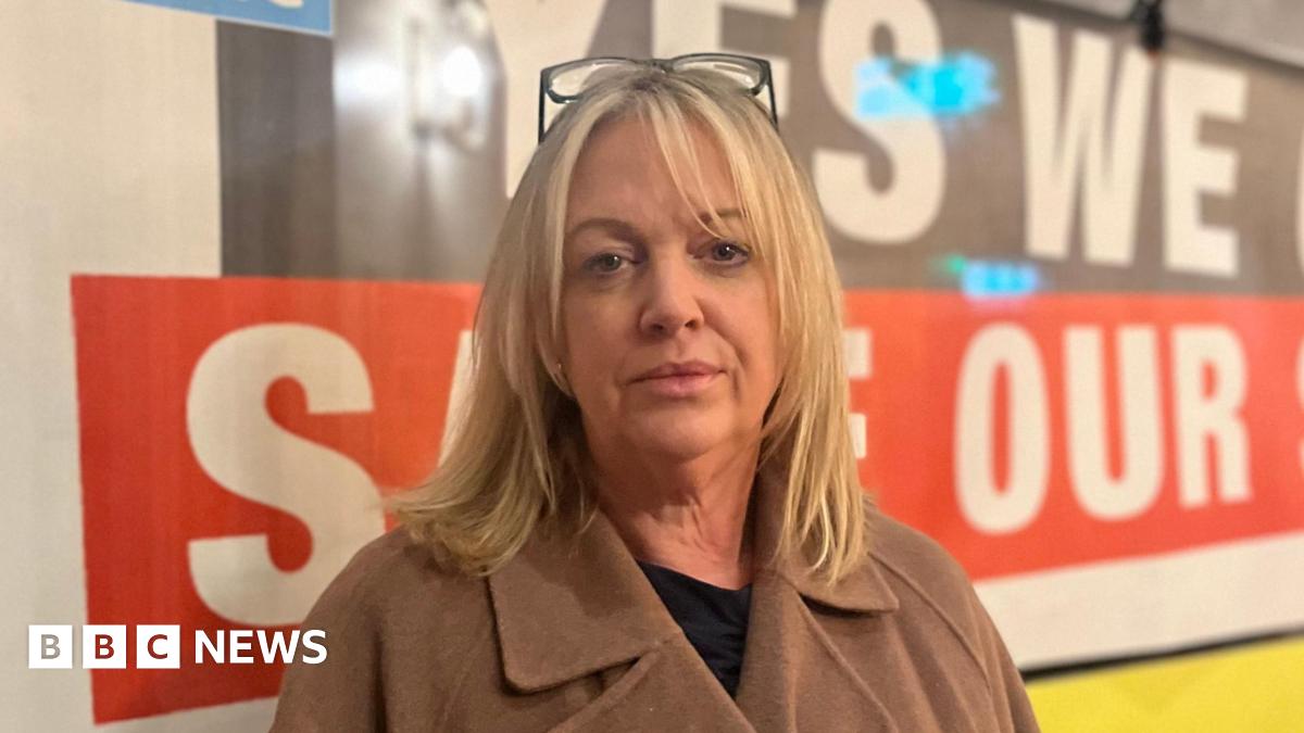 Prime Minister Mark Carney, wearing a black suit jacket, and a white button-up shirt leans his chin on his hands. He has short grey and black hair and is looking away from the camera.