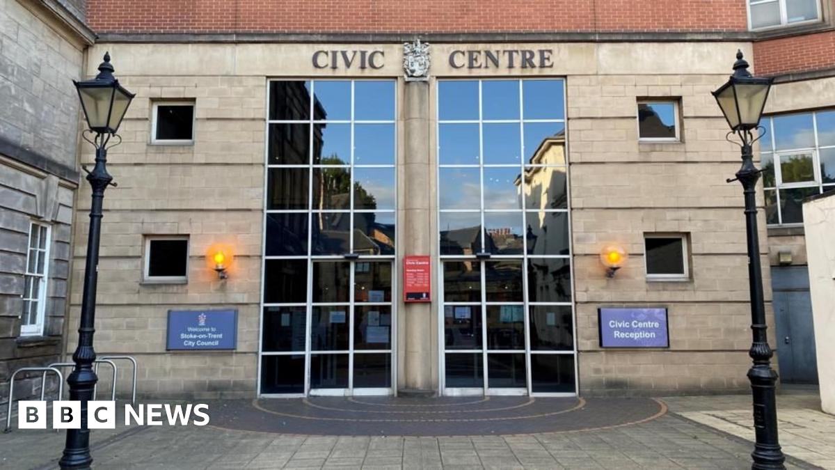 The front entrance to the Civic Centre in Stoke-on-Trent. The two sets of front doors and windows are made up of panels of grass. The words "civic centre" are above the entrance.