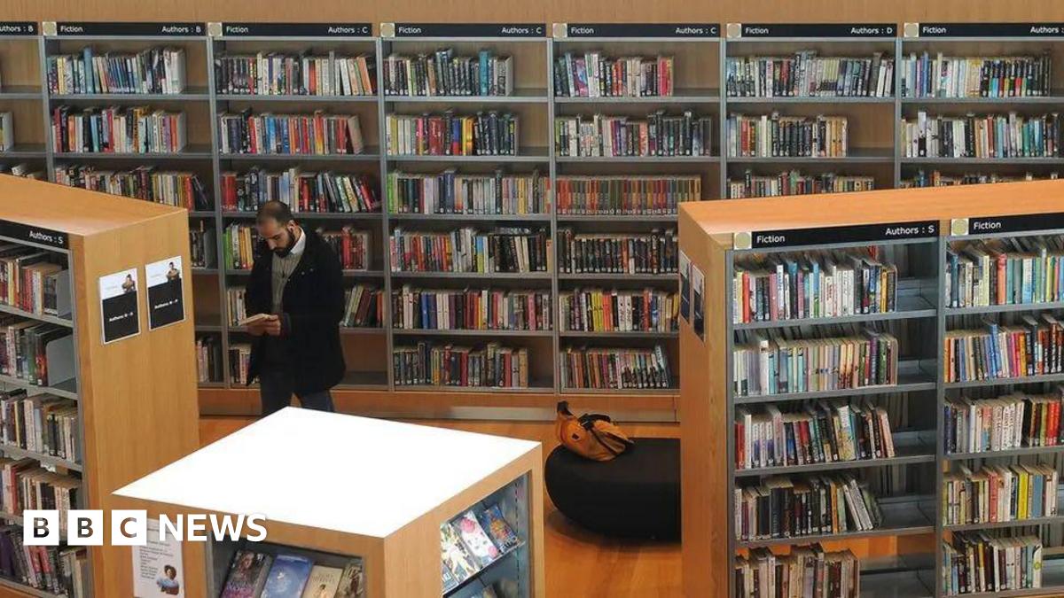 A man stood in a library