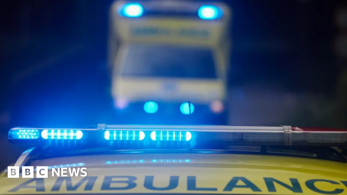 Yellow ambulance with blue lights on flashing