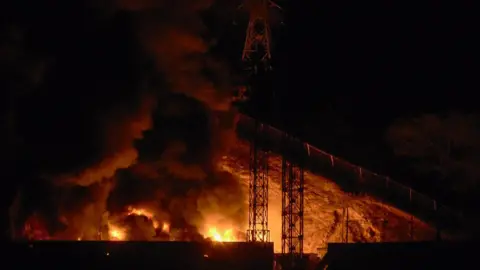 Getty Images Picture of a fire at Fuerte Tiuna, Venezuela's largest military complex, after a series of explosions in Caracas