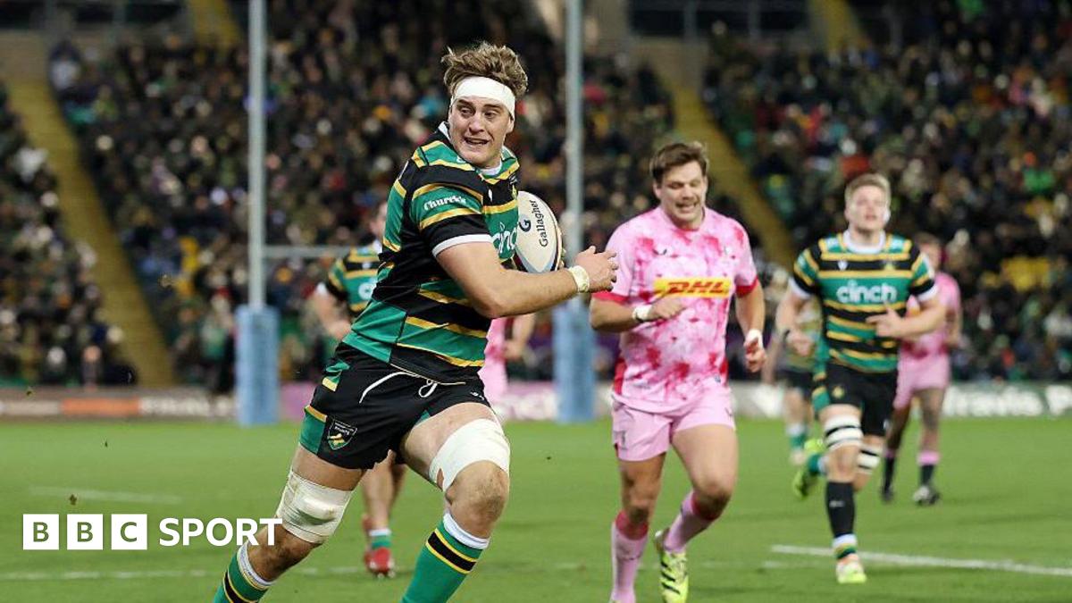 Alex Coles, wearing the gold, green and black of Northampton Saints, breaks through to go on and score against Harlequins.