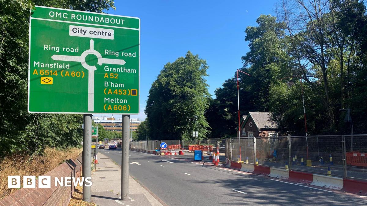 An image of the road leading up to the Priory Roundabout. A road sign in the foreground reads Priory Roundabout.