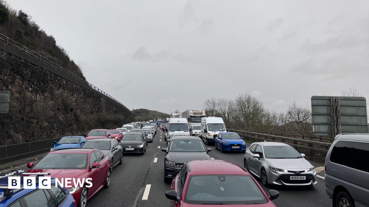 Cars queued up on the M5 motorway. They are facing toward the camera.