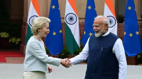 Hindustan Times via Getty Images Indian Prime Minister Narendra Modi shakes hands with European Commission President Ursula von der Leyen at Hyderabad House in Delhi on 28 February, 2025, with EU and India flags in the background. 