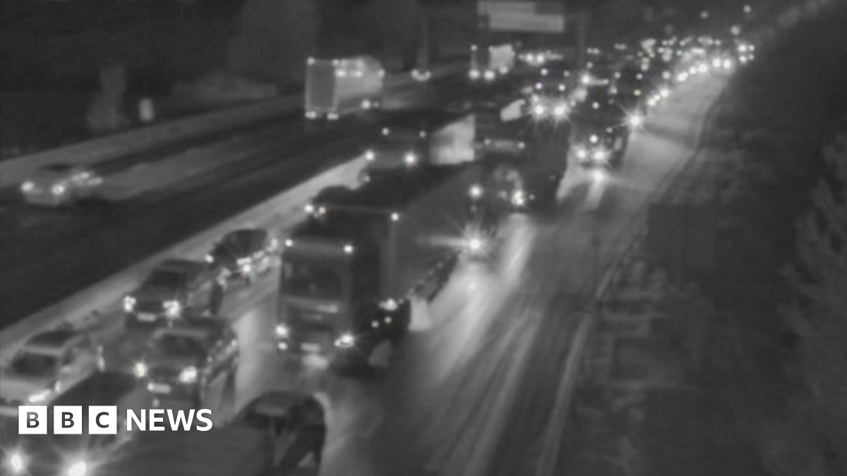 A black and white image of lines of traffic on a motorway