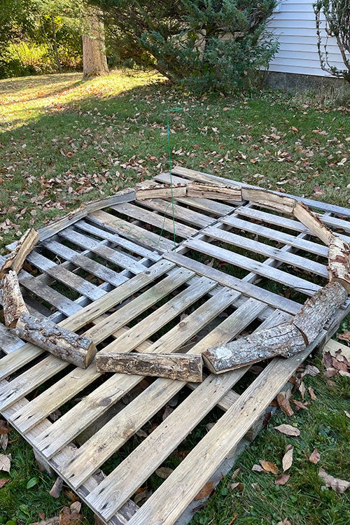 The beginning of a holzhausen: one row of split wood arranged in a circle.