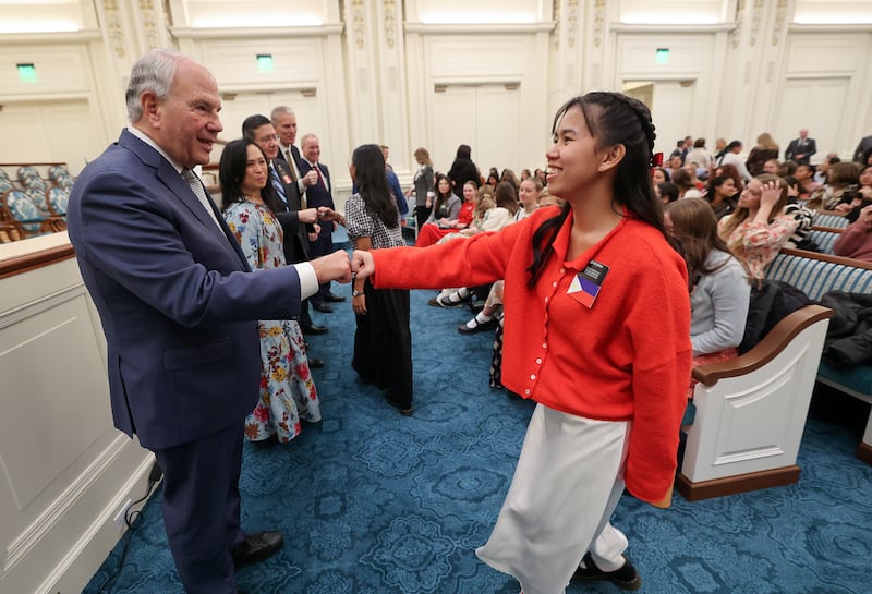 Elder Ronald A. Rasband fist bumps Sister Gwennever Espina at a missionary devotional at the Joseph Smith Memorial Building in Salt Lake City on Friday, Jan. 9, 2026.
