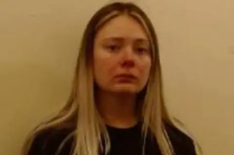 Police Scotland A police custody photo of a woman in her early 20s with blonde hair and a black top