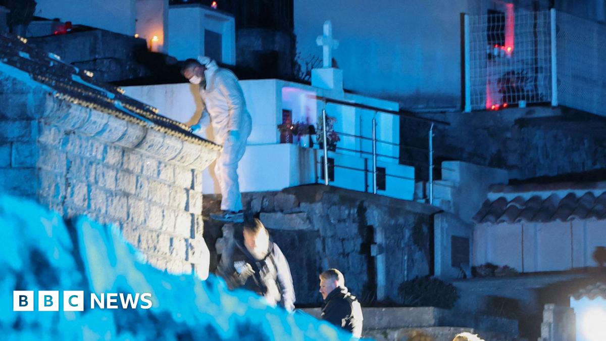 Forensic specialists look for evidence in a cemetery in Corsica in the dark on 12 January