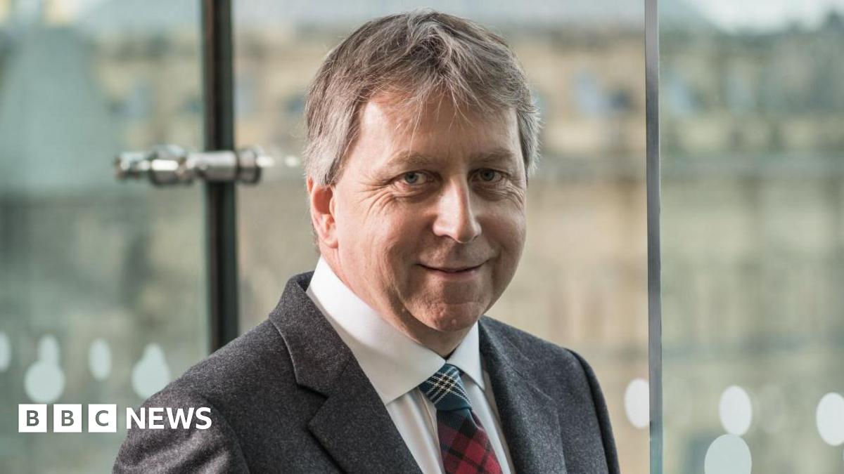 Prof Sir Peter Mathieson head and shoulders shot in a suit and tartan tie